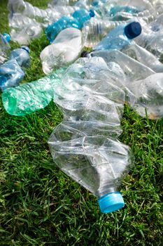 Sign of incivility used plastic bottles abandoned in a meadow 