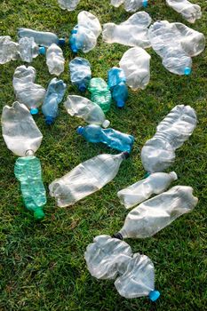 Sign of incivility used plastic bottles abandoned in a meadow 