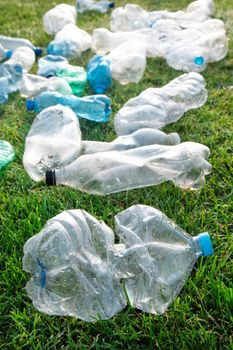 Sign of incivility used plastic bottles abandoned in a meadow 