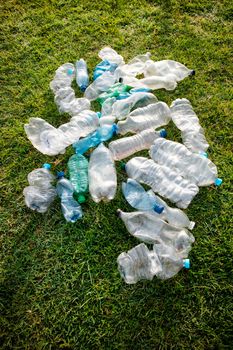 Sign of incivility used plastic bottles abandoned in a meadow 