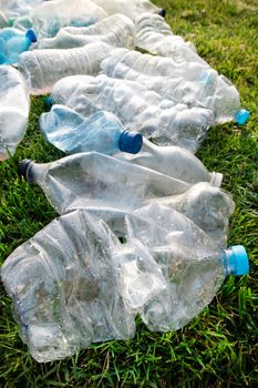 Sign of incivility used plastic bottles abandoned in a meadow 