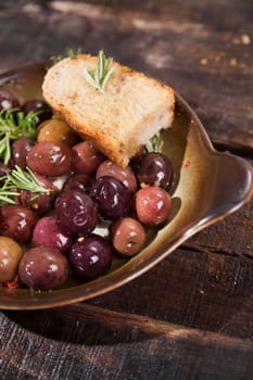 Snack of homemade bread and black olives in brine