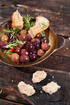 Snack of homemade bread and black olives in brine