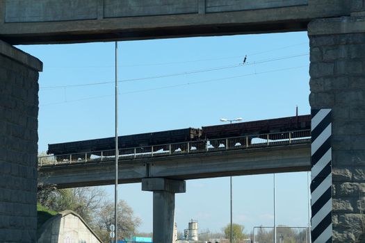 freight train rides over the railway bridge, bottom view.