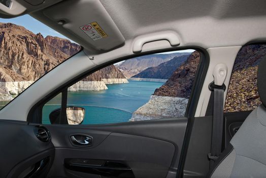 Looking through a car window with view of Colorado river in front of the Hoover Dam on the Nevada side, USA
