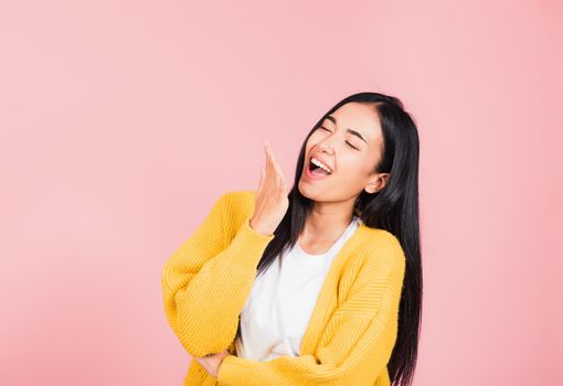 Happy Asian portrait beautiful cute young woman standing winning and surprised excited screaming laugh hand cover mouth, studio shot isolated pink background, Thai female wow scream with copy space