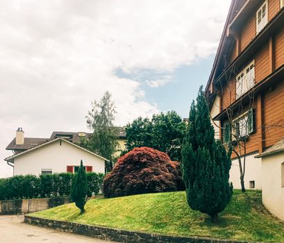 Wollerau, canton of Schwyz, Switzerland circa June 2021: Apartment building and house on street, Swiss architecture and real estate