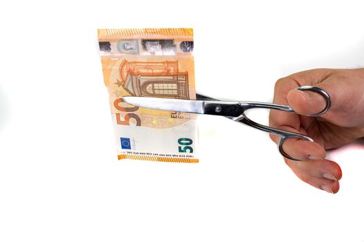 cut 50 euro banknotes with scissors on white background