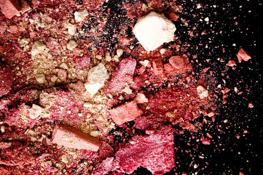 Crushed cosmetics, mineral organic eyeshadow, blush and cosmetic powder isolated on black background, makeup and beauty banner, flatlay design.