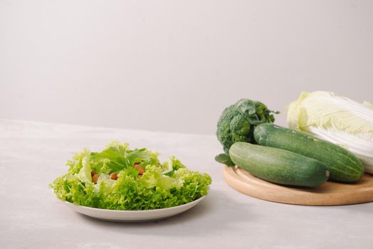 Various green organic salad ingredients on white background. Healthy lifestyle or detox diet food concept