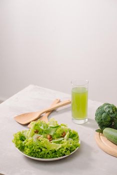 Various green organic salad ingredients on white background. Healthy lifestyle or detox diet food concept