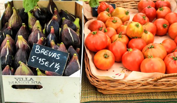 Elche, Alicante, Spain- January 26, 2021: Figs and tomatoes for sale at an ecological and sustainable market held in the countryside of Elche