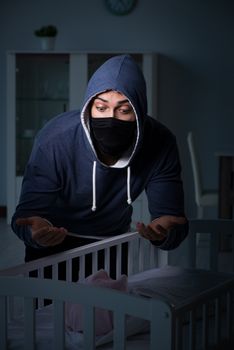 Criminal stealing baby in human child traficking concept