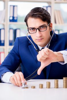 Businessman with stacks of coins in the office