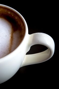 Hot milk coffee and soft froth in white ceramic cup