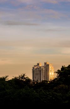 Light of the sun Glare at glass of high-rise building in the twilight