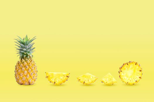 Collection of group pineapples and sliced isolated on yellow pastel colors background.
