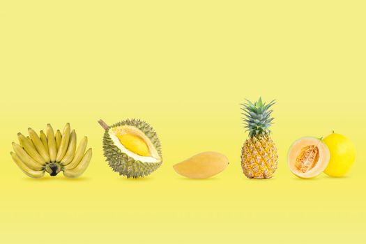 Collection of group of yellow color fruits isolated on yellow pastel colors background.