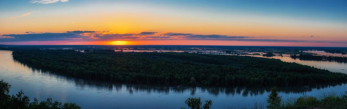 Big panoramic picture view of river landscape in sunny summer evening. View of siberian Ob river from in summer sunset.