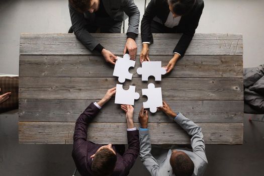 Business teamwork with puzzle finishing project cooperation unity concept