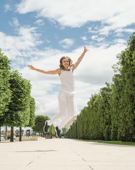 Happy young woman in white t-shirt jumping and screaming in the park. mock up design