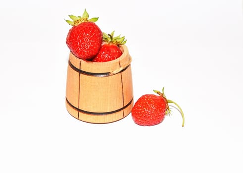 Ripe berries of summer harvest strawberries in a wooden barrel