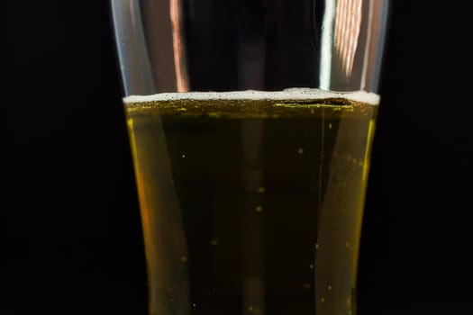 Close-up of beer pint with free space for text. Abstract beverages background