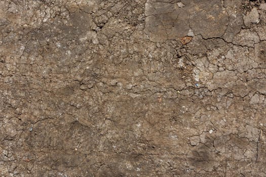 dry rammed bare earth surface under direct sunlight - full frame background and texture.