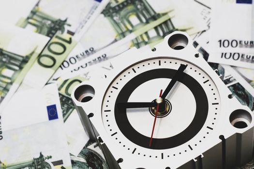 Clock and banknotes, a symbol of how time is money. Business concept.