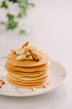 banana cashew pancakes with bananas and salted caramel sauce. the toning. selective focus