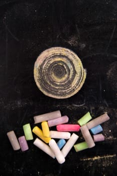 Background of blackboard with pieces of chalk to artistic use