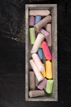 Background of blackboard with pieces of chalk to artistic use