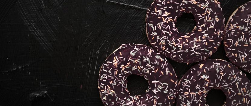 Bakery, branding and cafe concept - Frosted sprinkled donuts, sweet pastry dessert on rustic wooden background, doughnuts as tasty snack, top view food brand flat lay for blog, menu or cookbook design