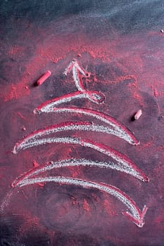 Graphical representation of a Christmas tree drawn with chalk on blackboard