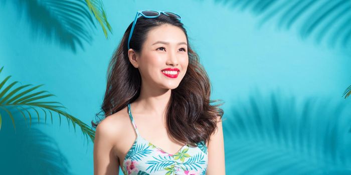 Banner size. Summer fashion girl standing and smiling over vibrant blue background