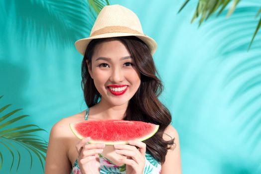 Beautiful girl with red lips eating watermelon.