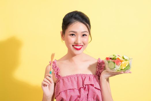 Asian beautiful woman summer outfit posing with fresh bowl of salad