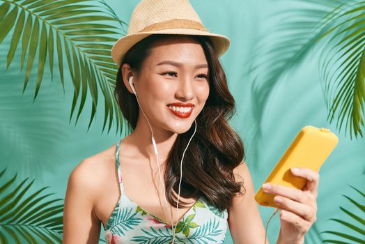 Asian women selfie herself on blue backgound. Asian women happy for travel on summer