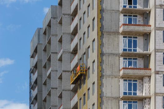 construction cradle on a multi-apartment residential building under construction.