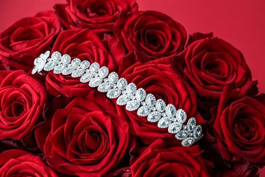 Gemstone jewellery, wedding fashion and luxe shopping concept - Luxury diamond bracelet and bouquet of red roses, jewelry love gift on Valentines Day and romantic holidays present