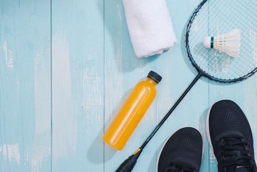 Sport equipment and footwear on wooden background