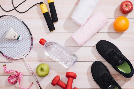Sport equipment and footwear on wooden background