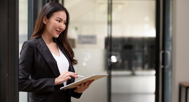 close up asian woman holding tablet pad with smart pen devices with copyspace