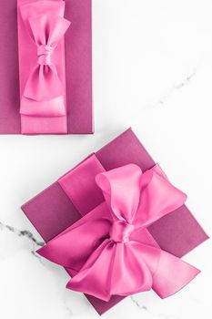 Birthday, wedding and girly branding concept - Pink gift box with silk bow on marble background, girl baby shower present and glamour fashion gift for luxury beauty brand, holiday flatlay art design