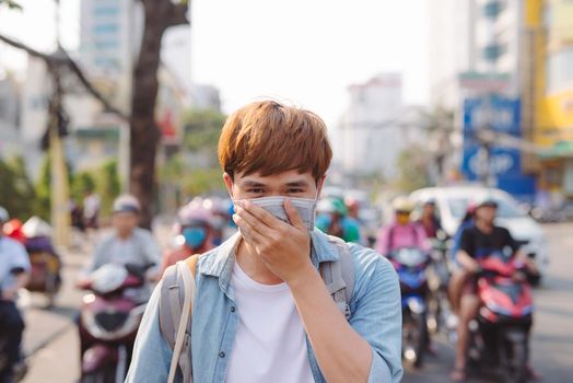 Asian man in the street wearing protective masks., Sick man with flu wearing mask and blowing nose into napkin as epidemic flu concept on the street.