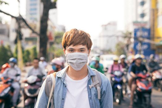 Young Asian man living in city with polluted air