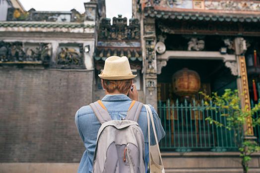 Young traveler taking pictures of the ancient city in asia style