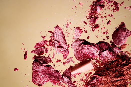 Crushed cosmetics, mineral organic eyeshadow, blush and cosmetic powder isolated on golden background, makeup and beauty banner, flatlay design.