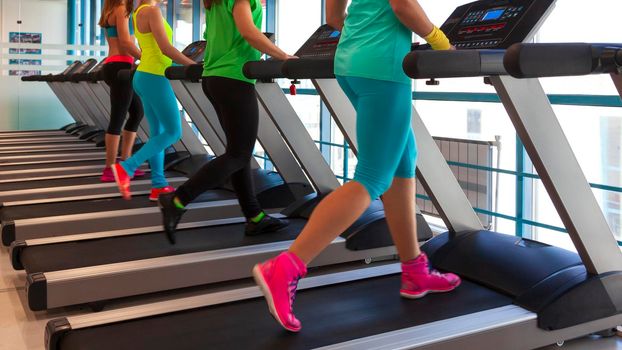 people running on treadmills in a gym