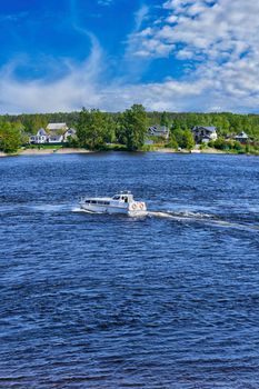 The river boat transports people to the other side. River crossing by water